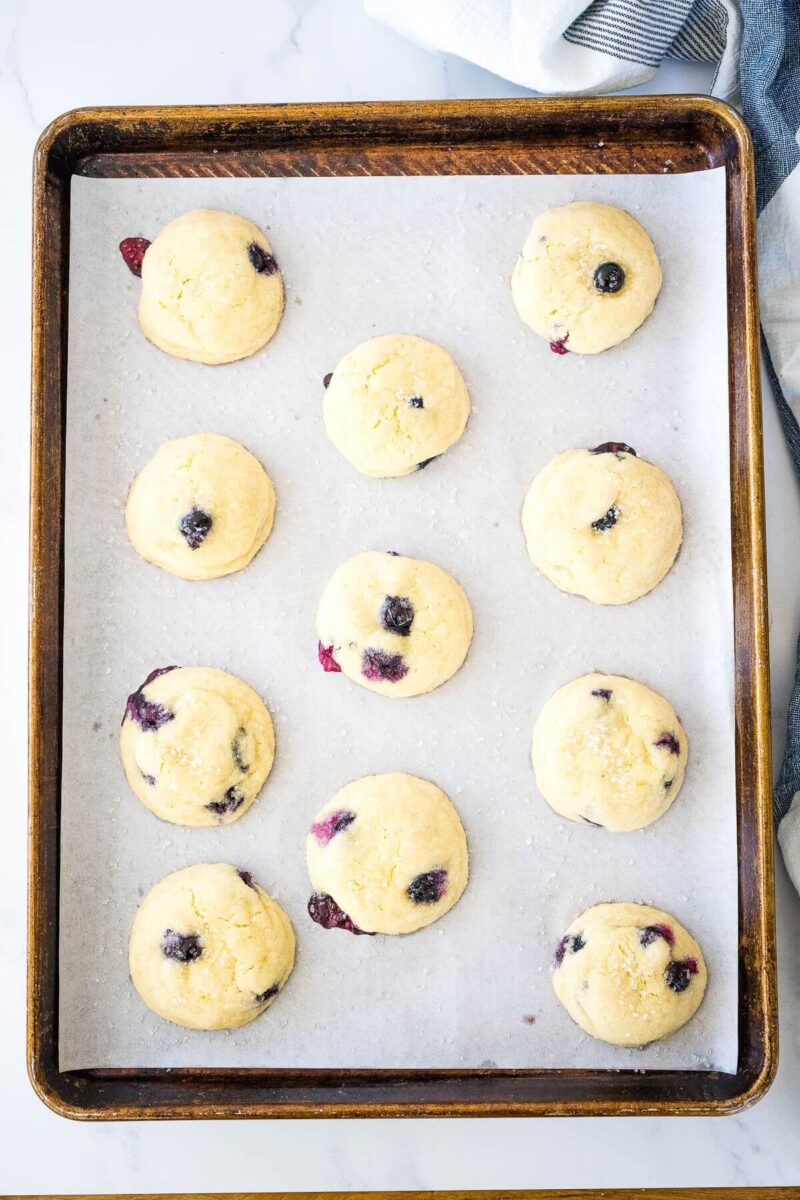 Lemon blueberry cookies on baking sheet, cooling. 