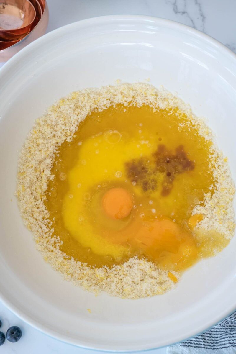 Adding eggs, egg yolk and vanilla to mixture. 