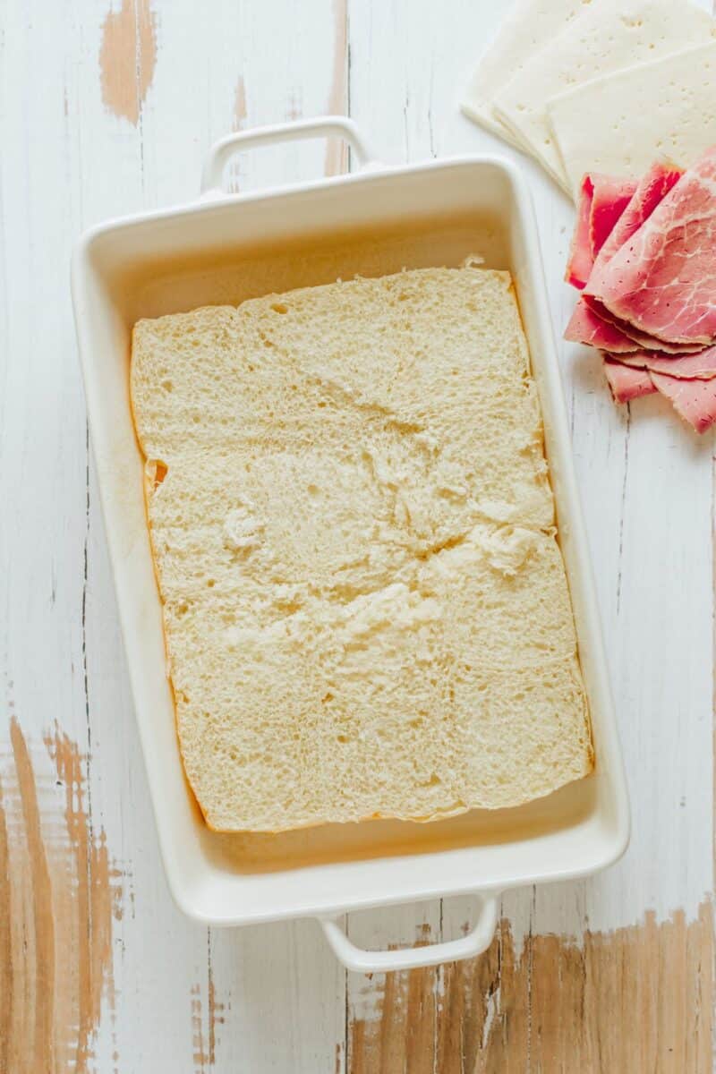 Bottoms of King's Hawaiian Sweet Rolls in baking dish. 