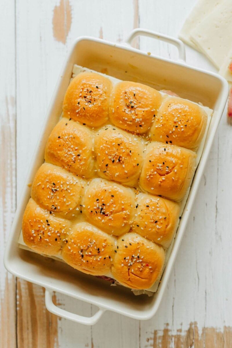A whole baking dish shows Hawaiian rolls covered in Everything but the Bagel seasoning.