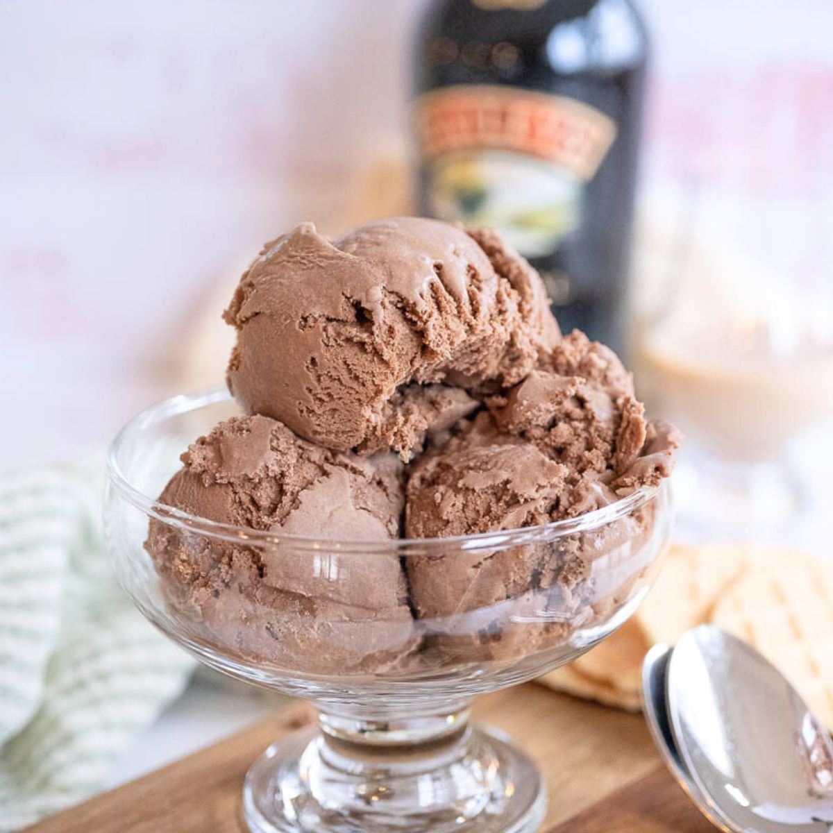 Footed glass bowl filled with three scoops of creamy Baileys Irish Cream Ice Cream.