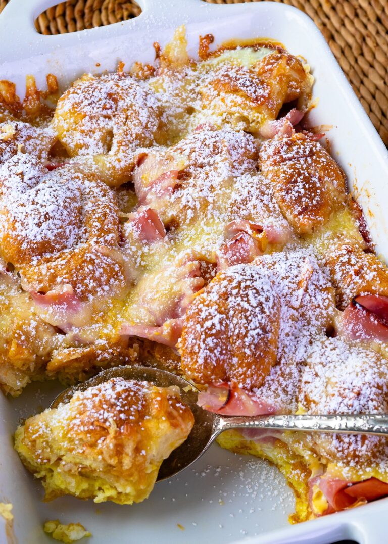 Ham and cheese croissant bake with powdered sugar sprinkled on top.