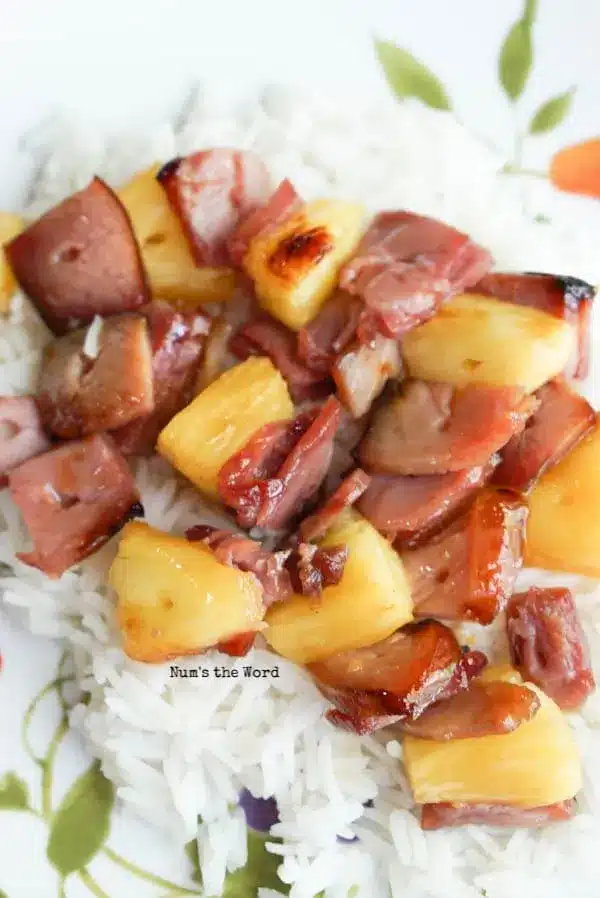 Ham and pineapple kabobs on white rice.