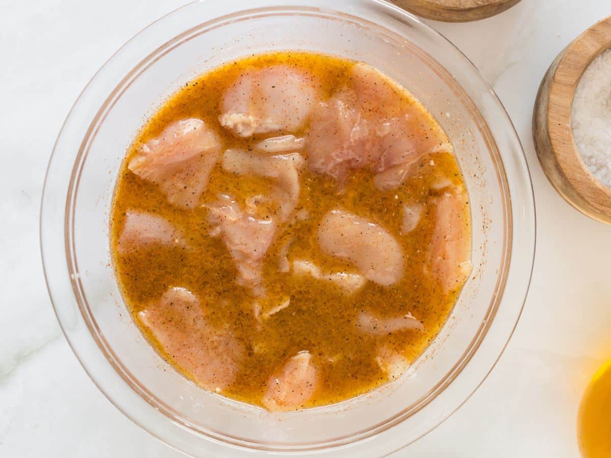 Raw chicken chunks in marinade/brine.