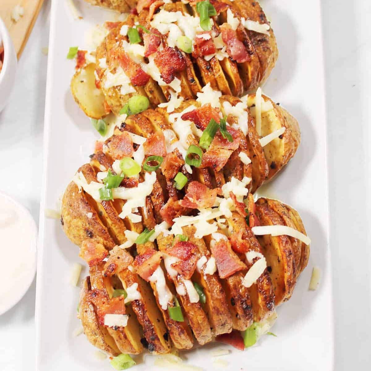 Air fryer hasselback potatoes on a platter.