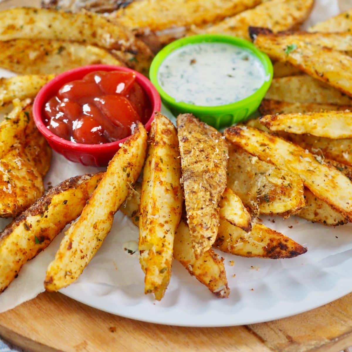Air Fryer Steak Fries with ketchup and ranch dressing for dipping.
