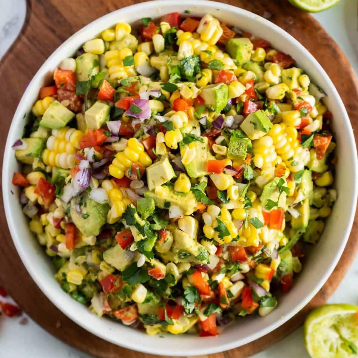 A large bowl of avocado corn salad, bright, inviting and vibrant!