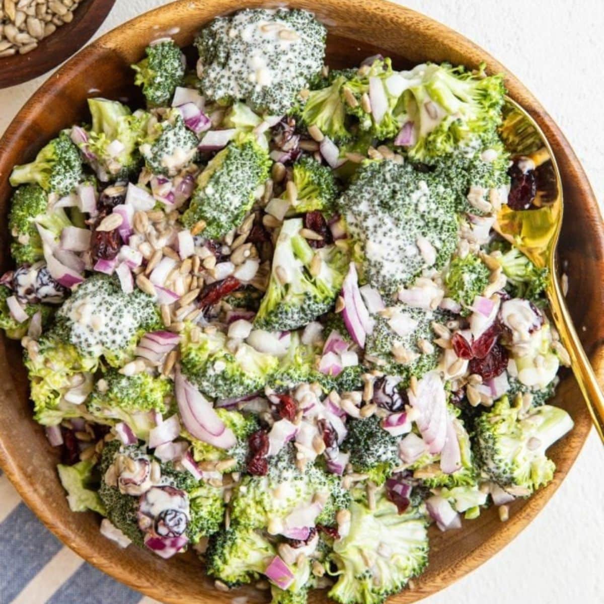 Creamy broccoli salad in a wooden salad bowl.