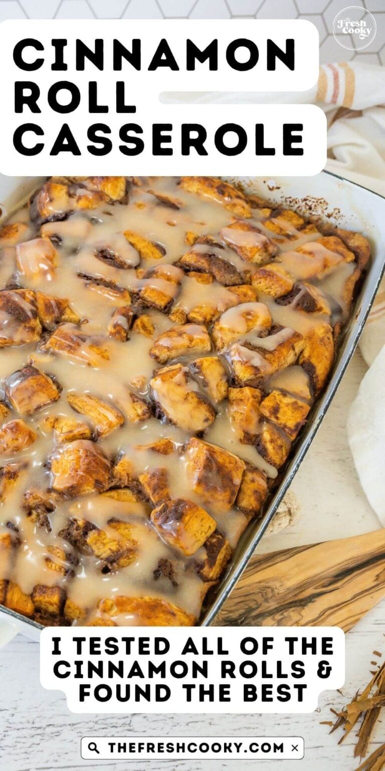Looking down on a pan of gooey cinnamon roll casserole in a white baking dish, for pinning.