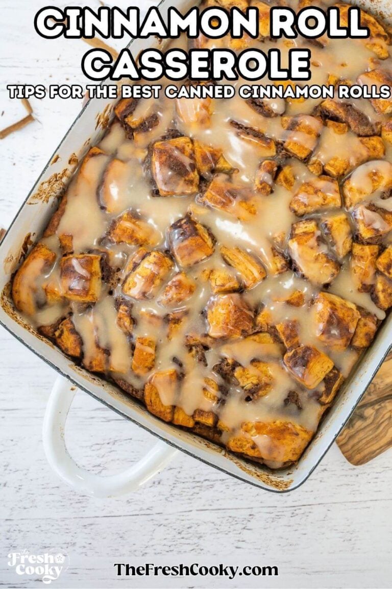 Looking down on a pan of cooked cinnamon roll casserole topped with a glaze, ready to eat. For pinning.