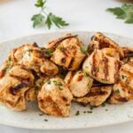 Grilled chicken nuggets on a small serving plate.