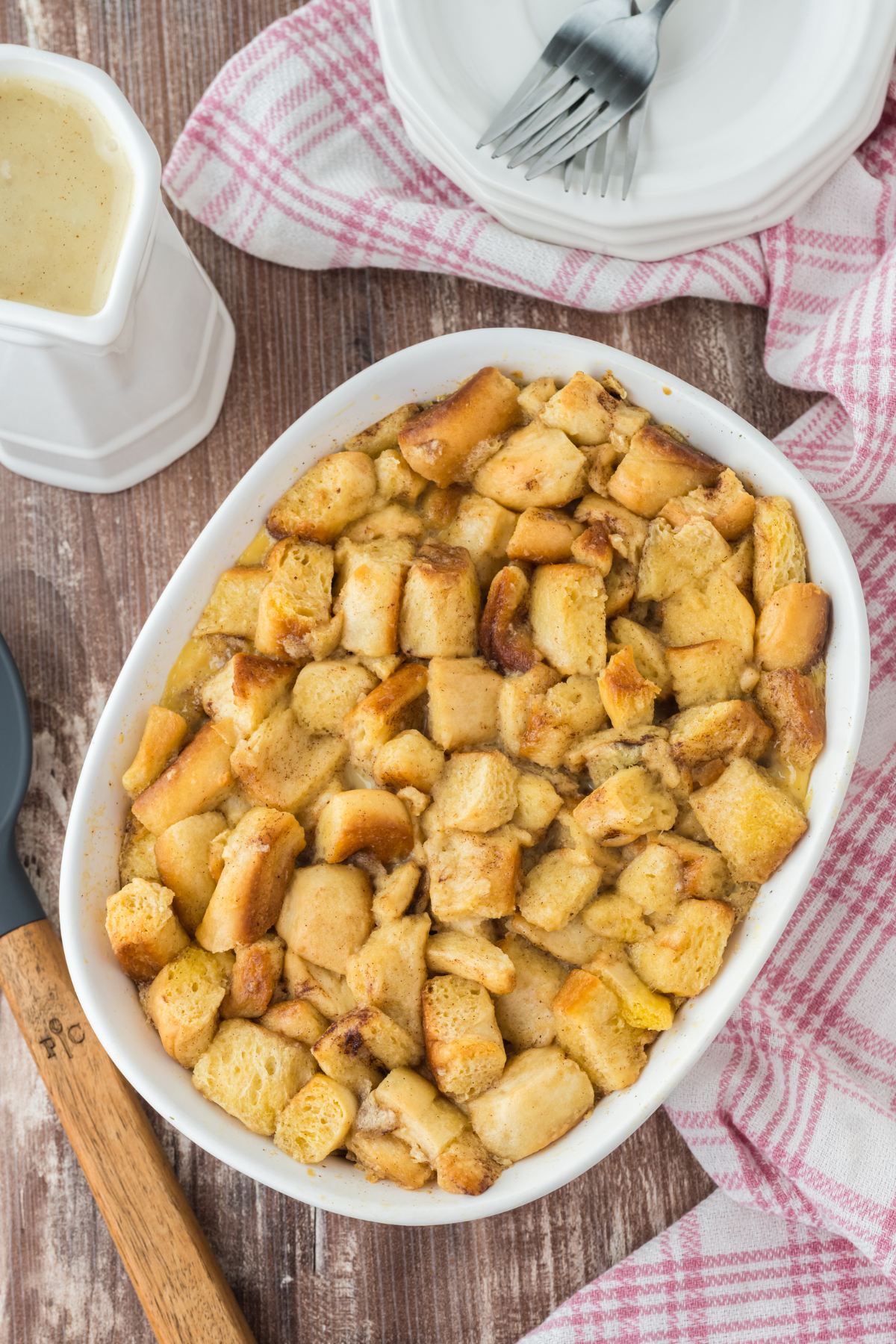 Baked casserole dish filled with leftover cinnamon roll bread pudding. 