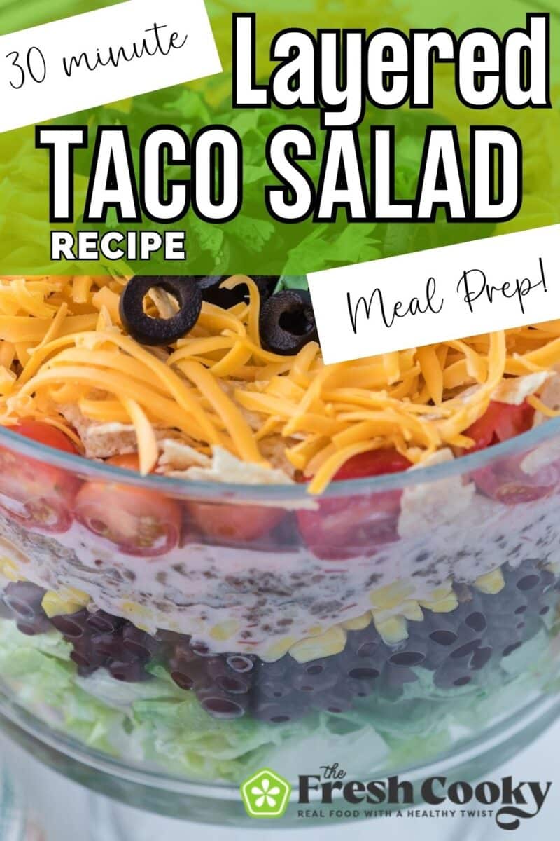 Close up of layers of taco salad in a glass trifle bowl to pin.