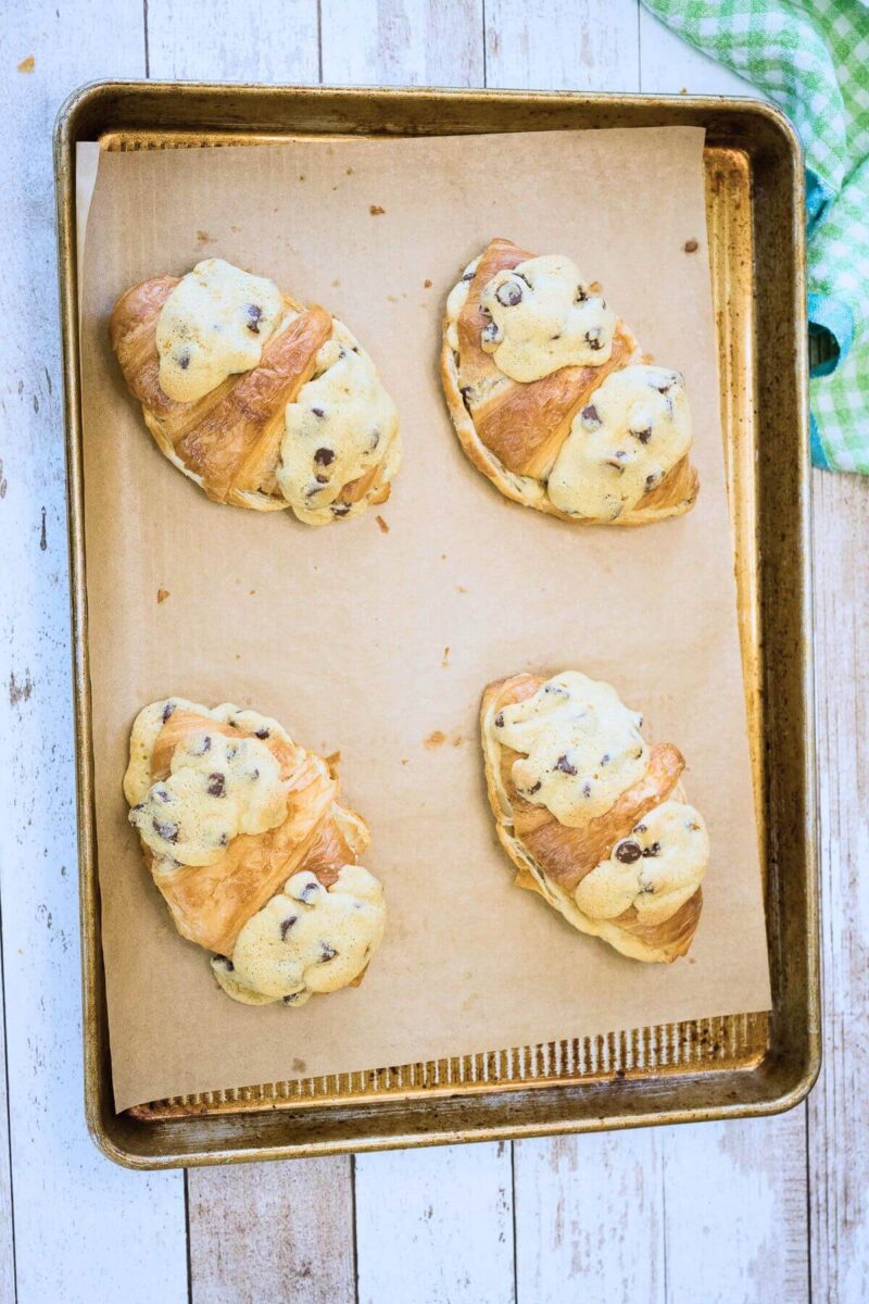 Baked cookie croissants on baking sheet. 
