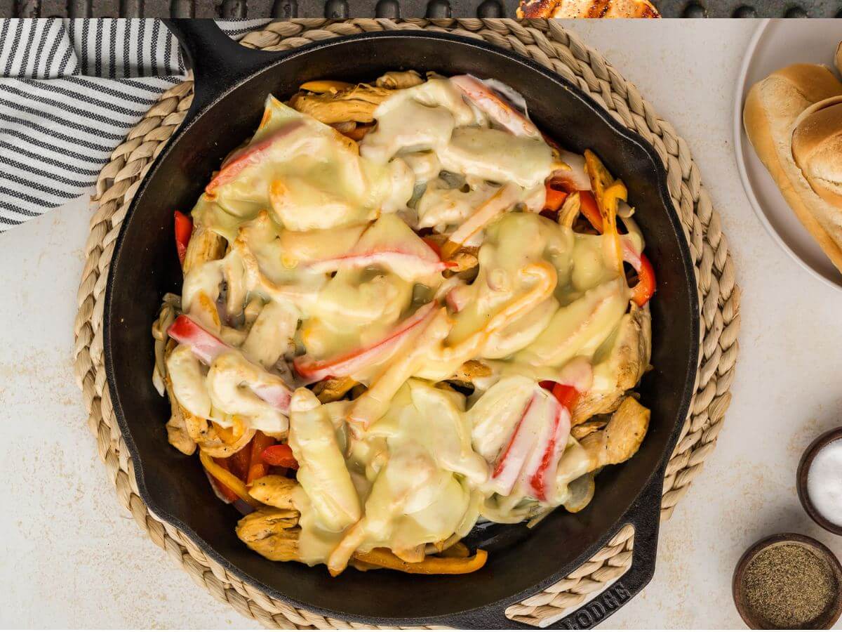 Melty cheese on top of chicken and vegetables. 