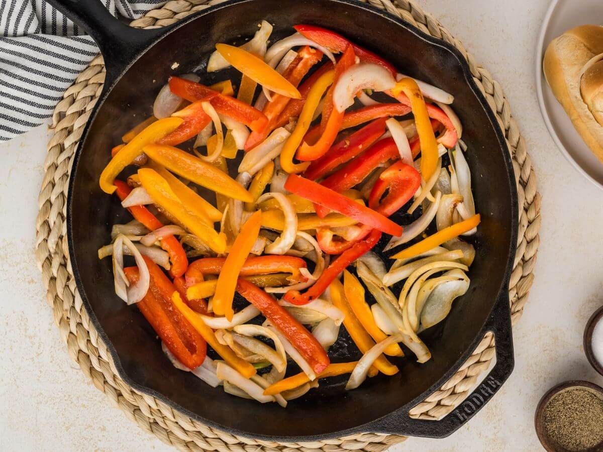Sauteeing onions and peppers in a cast iron skillet. 