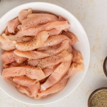 Raw chicken strips tossed with salt and pepper.