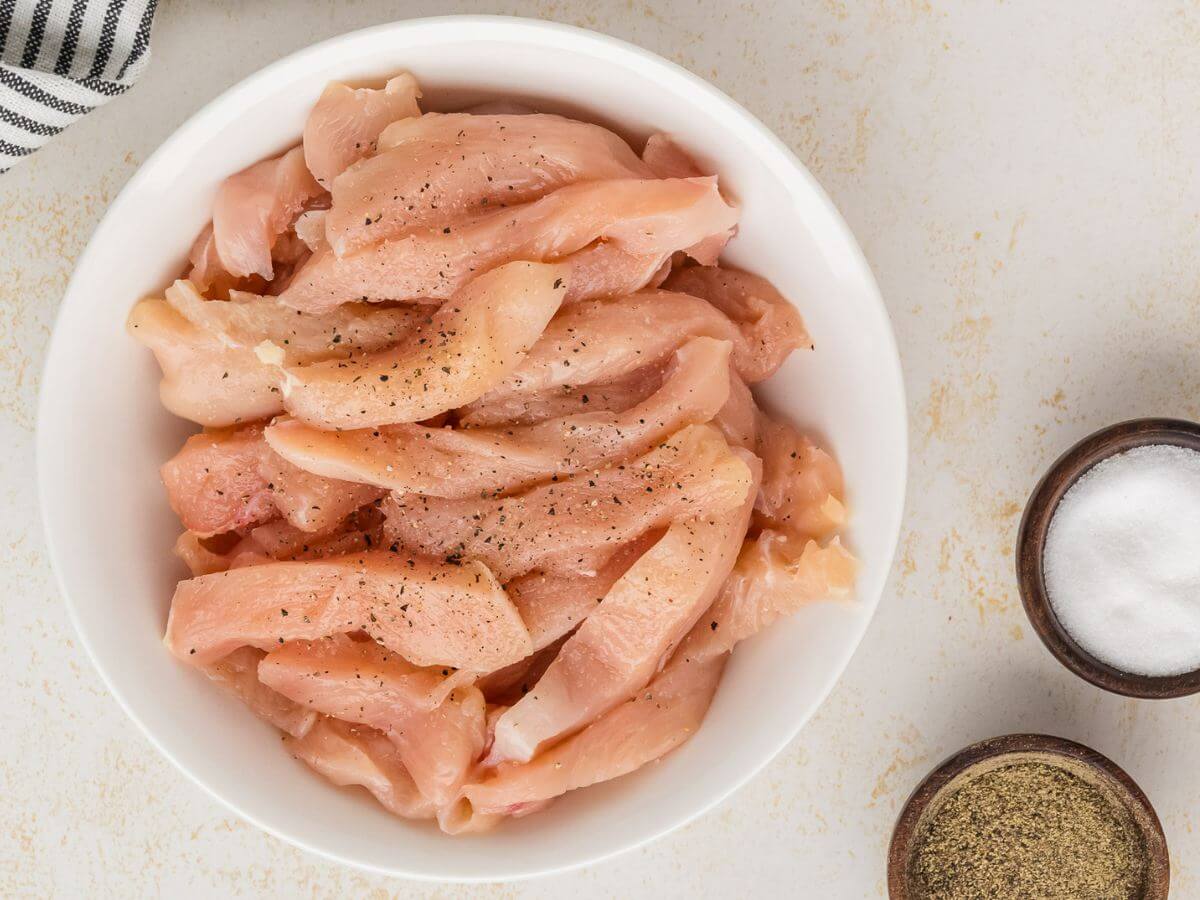 Raw chicken strips tossed with salt and pepper. 