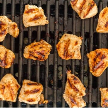 Chicken nuggets with grill marks on grill grate.