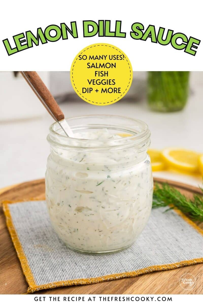 Jar of lemon dill dressing with a spoon, for pinning.