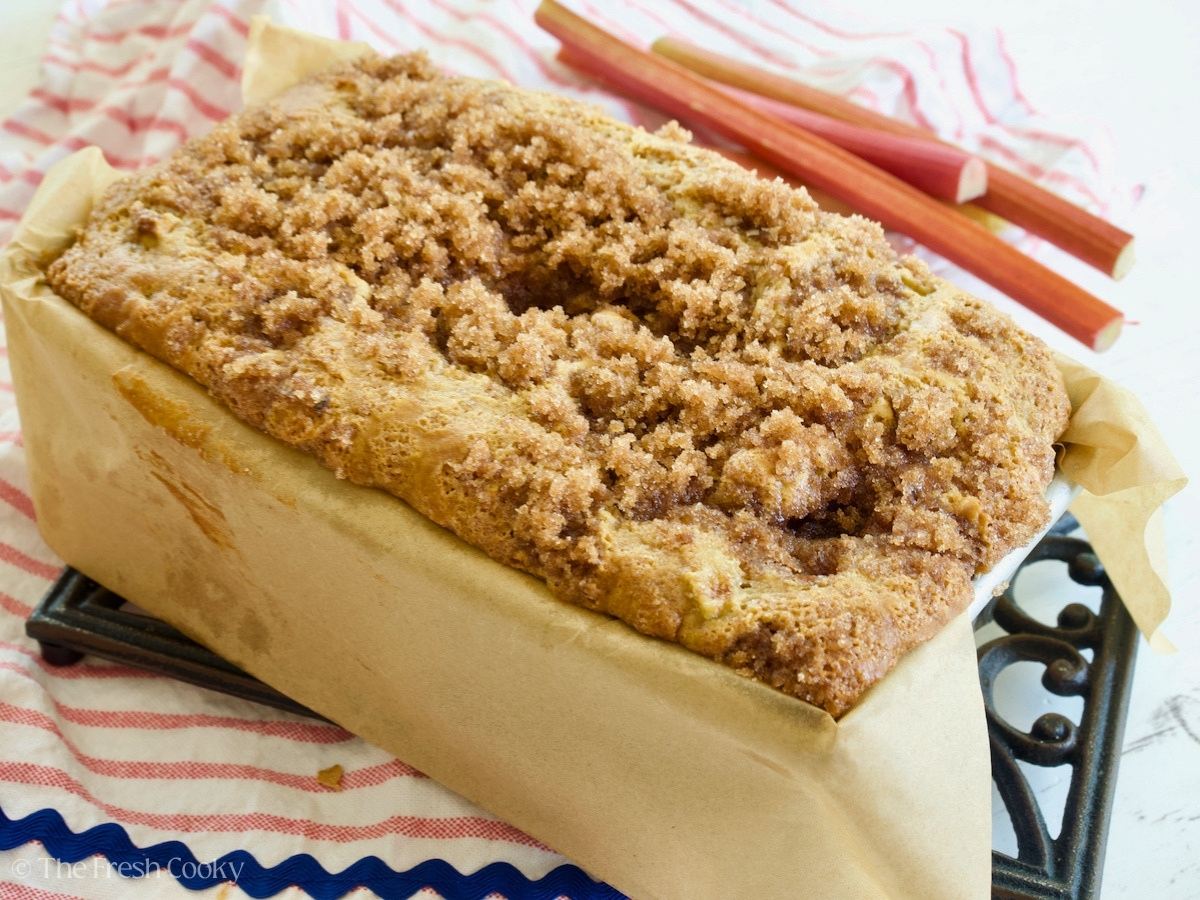 Buttermilk rhubarb bread in loaf pan with cinnamon streusel topping.