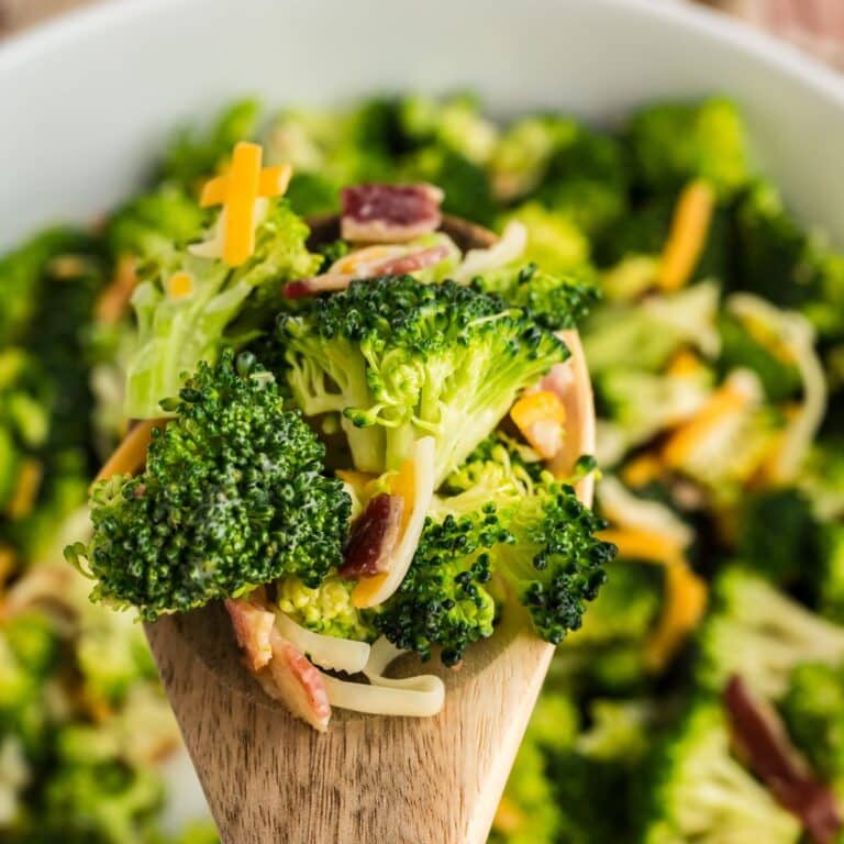 Chicken Salad Chick Broccoli Salad spoonful on a wooden spoon.