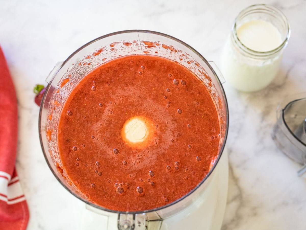 Pureed strawberries in food processor. 