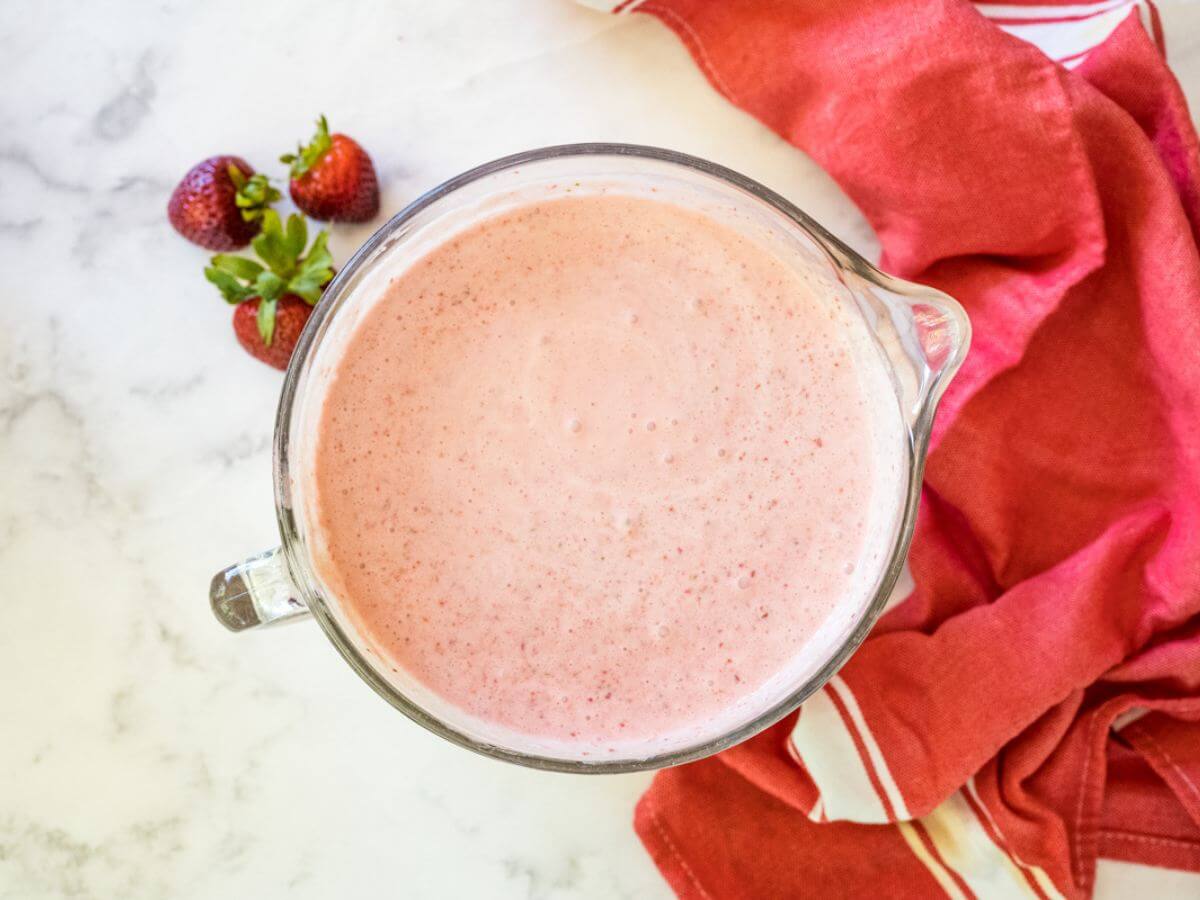 Pink strawberry ice cream in bowl ready to chill. 