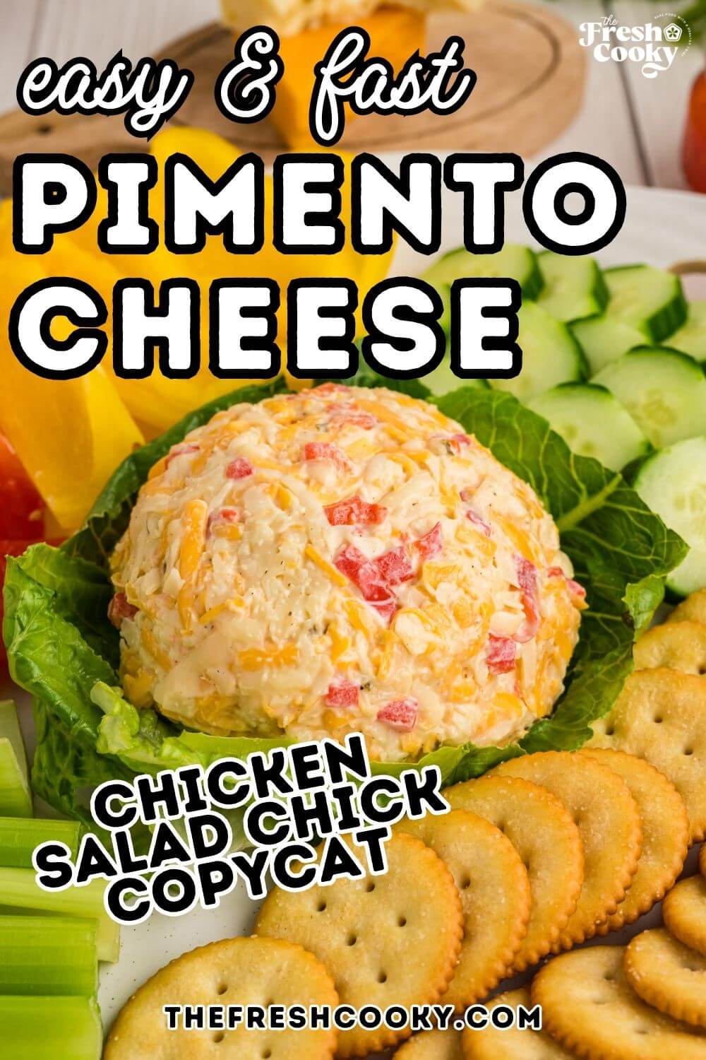 A ball of pimento cheese spread on a lettuce leaf with crackers and veggies surrounding it, to pin.