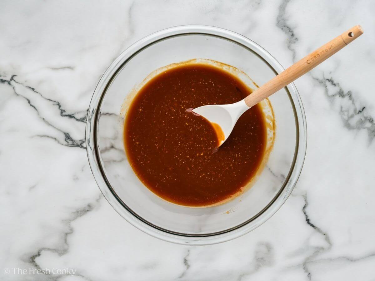 Mixing together the sauce for the bacon baked beans. 