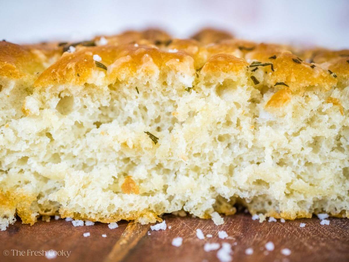 Side view of focaccia bread to show the fluffy inside.