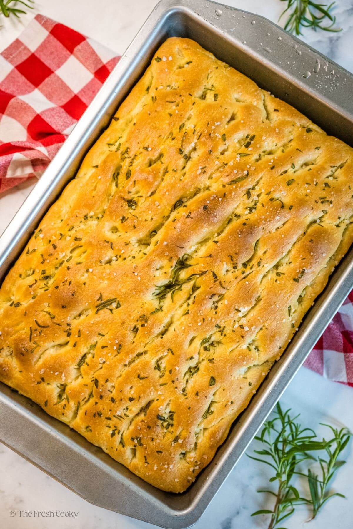 Overhead shot of baked focaccia bread in a baking dish.