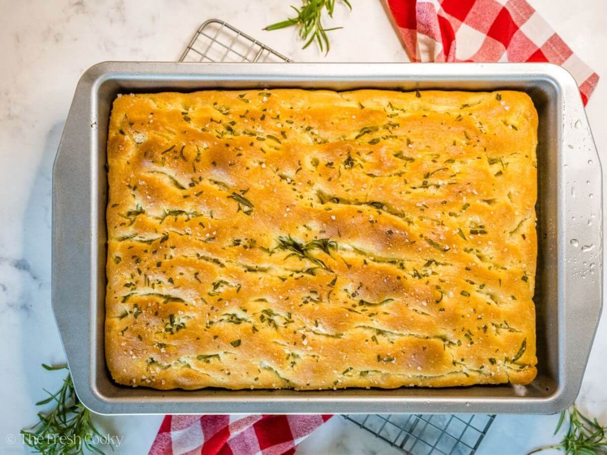 Focaccia bread baked and still in the baking dish.