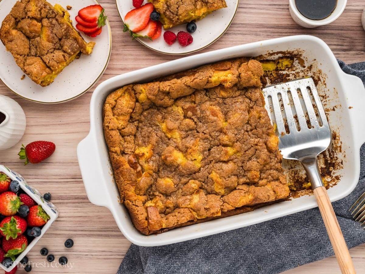 Overnight French Toast Casserole with spatula serving a few slices.
