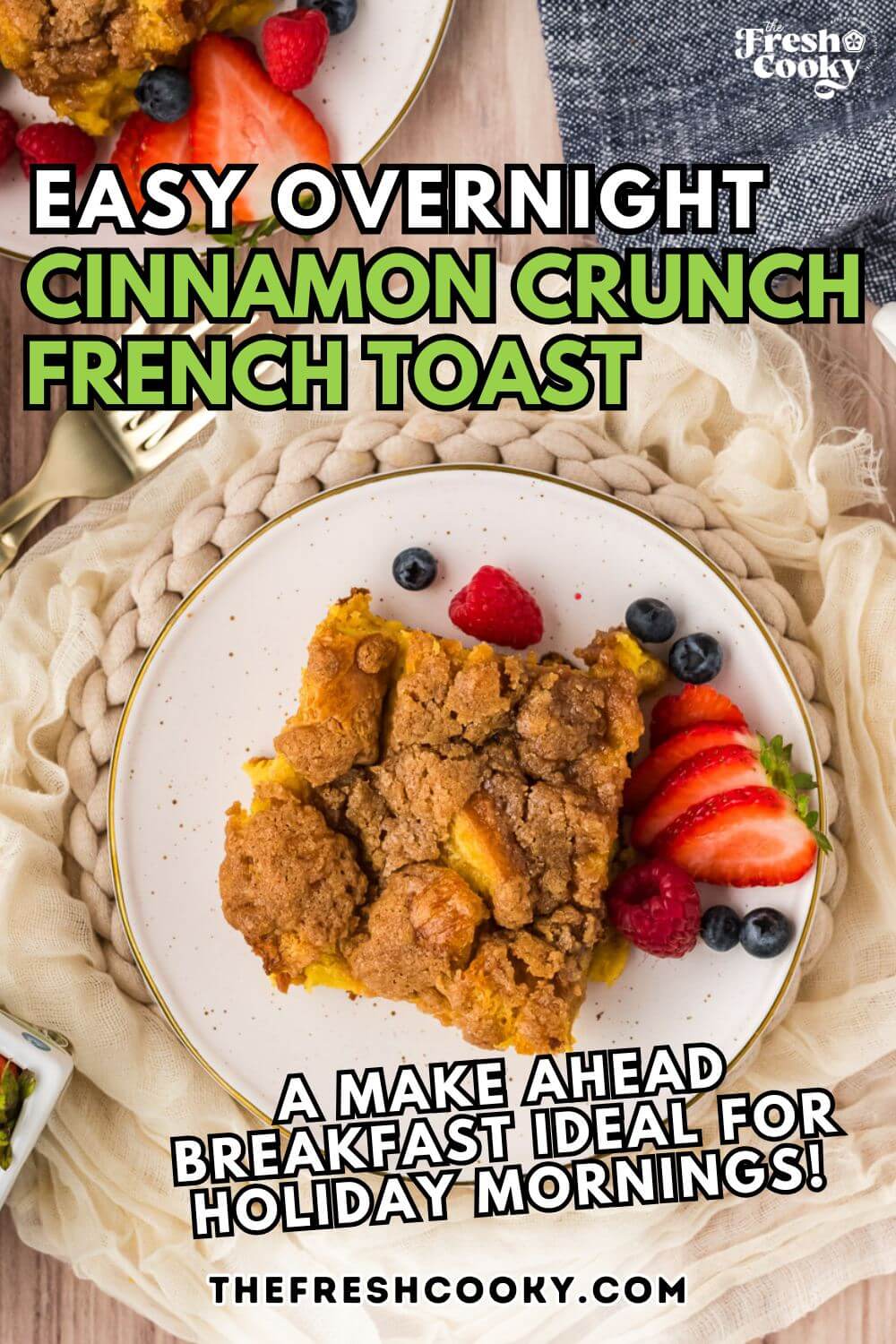 Slice of warm Overnight French Toast casserole on a plate, served with berries, for pinning. 