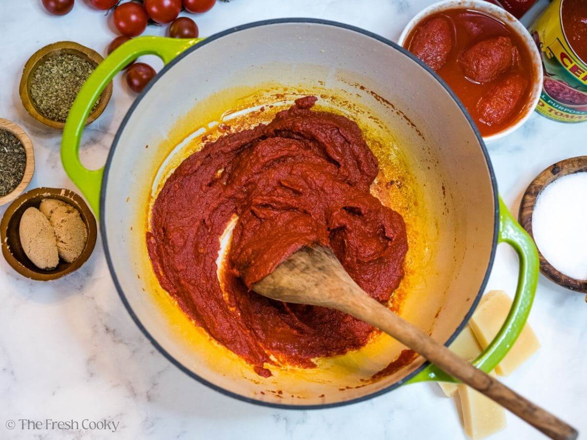 Browning the tomato paste in the bottom of a Dutch oven.