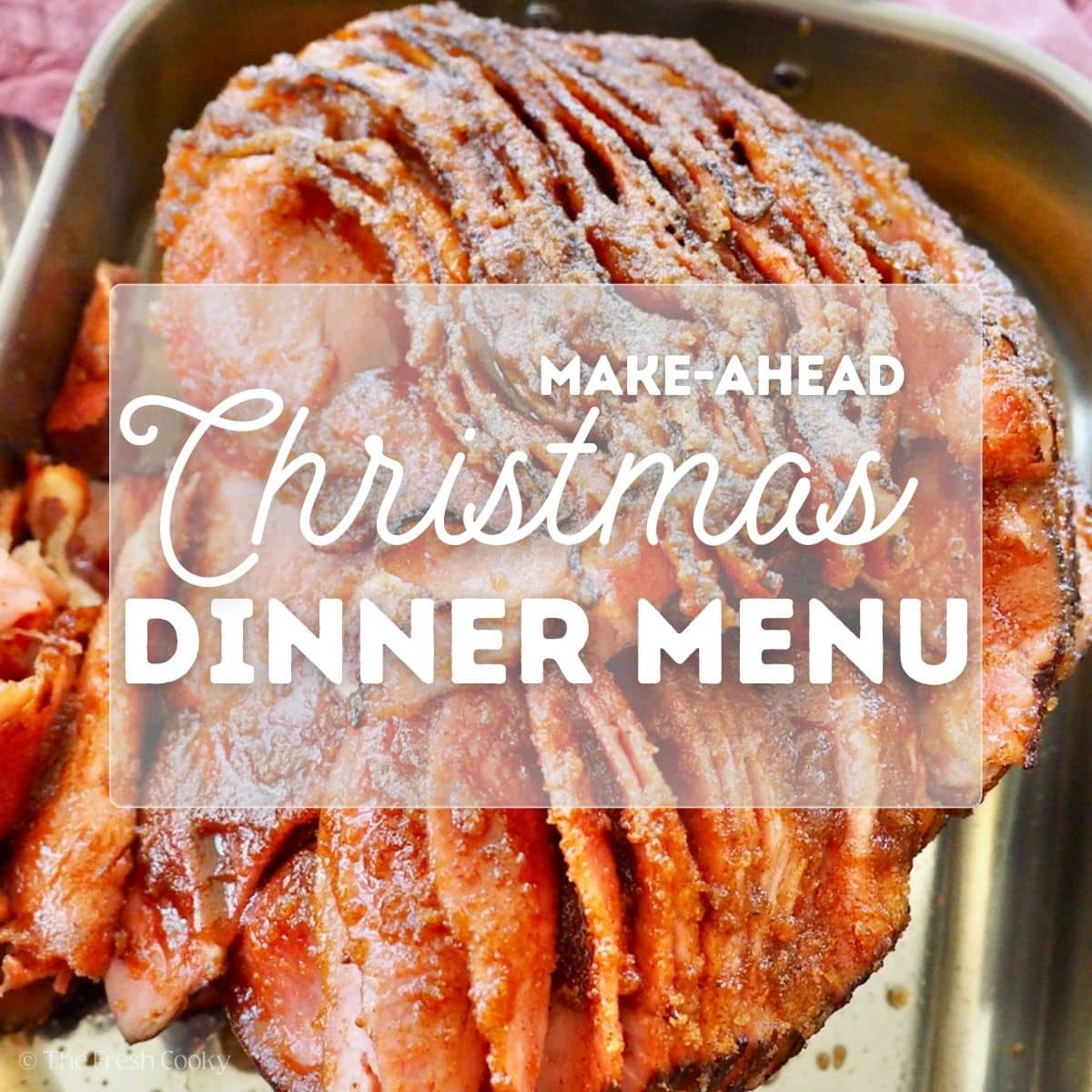 A close-up of a sugar crusted honey-baked spiral ham in a roasting pan for pinning.
