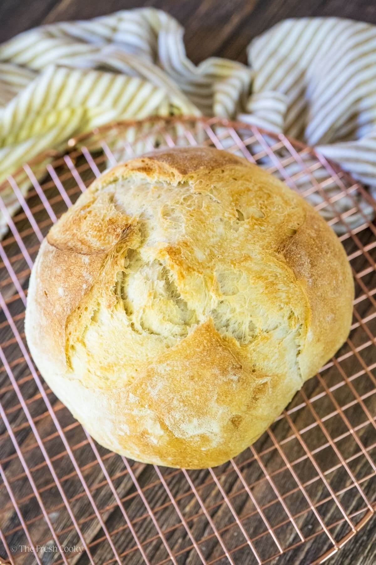 Sourdough loaf on a wire cooling wrack.