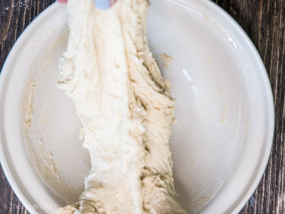 Stretching out the dough in a bowl.