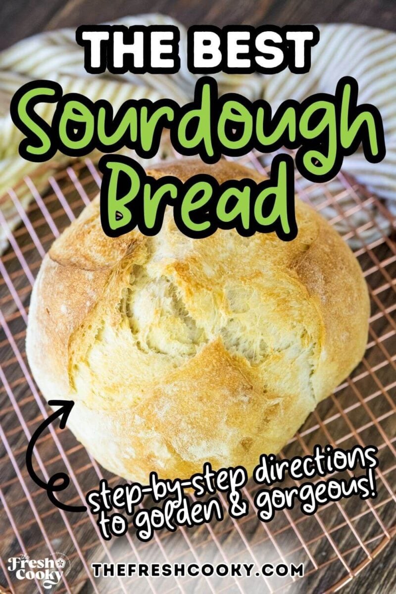 A golden, crusty loaf of sourdough bread on a cooling rack, to pin.