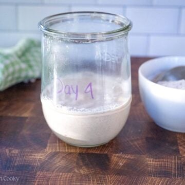 Sourdough starter in a jar labeled "day 4".