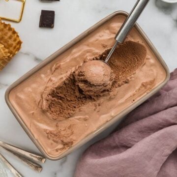 Chocolate ice cream frozen with a scoop.