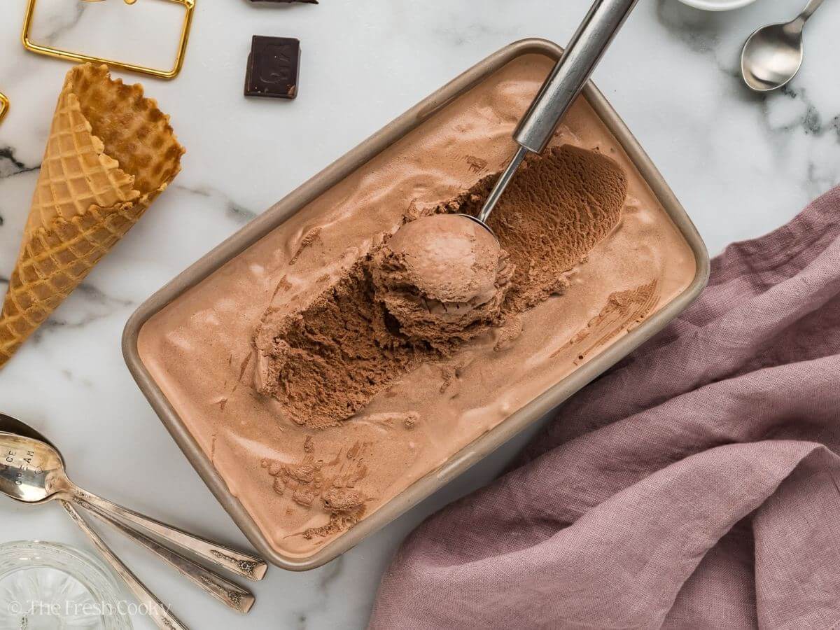 Chocolate ice cream frozen with a scoop.