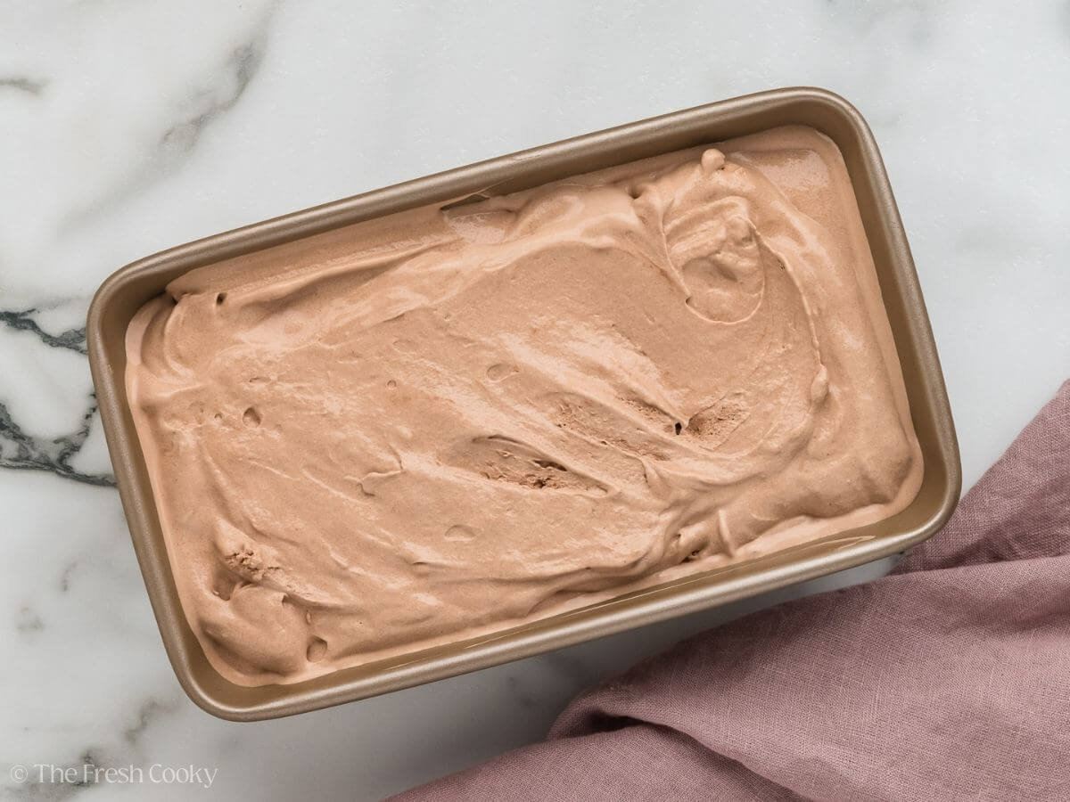 Chocolate ice cream smoothed into a loaf pan. 