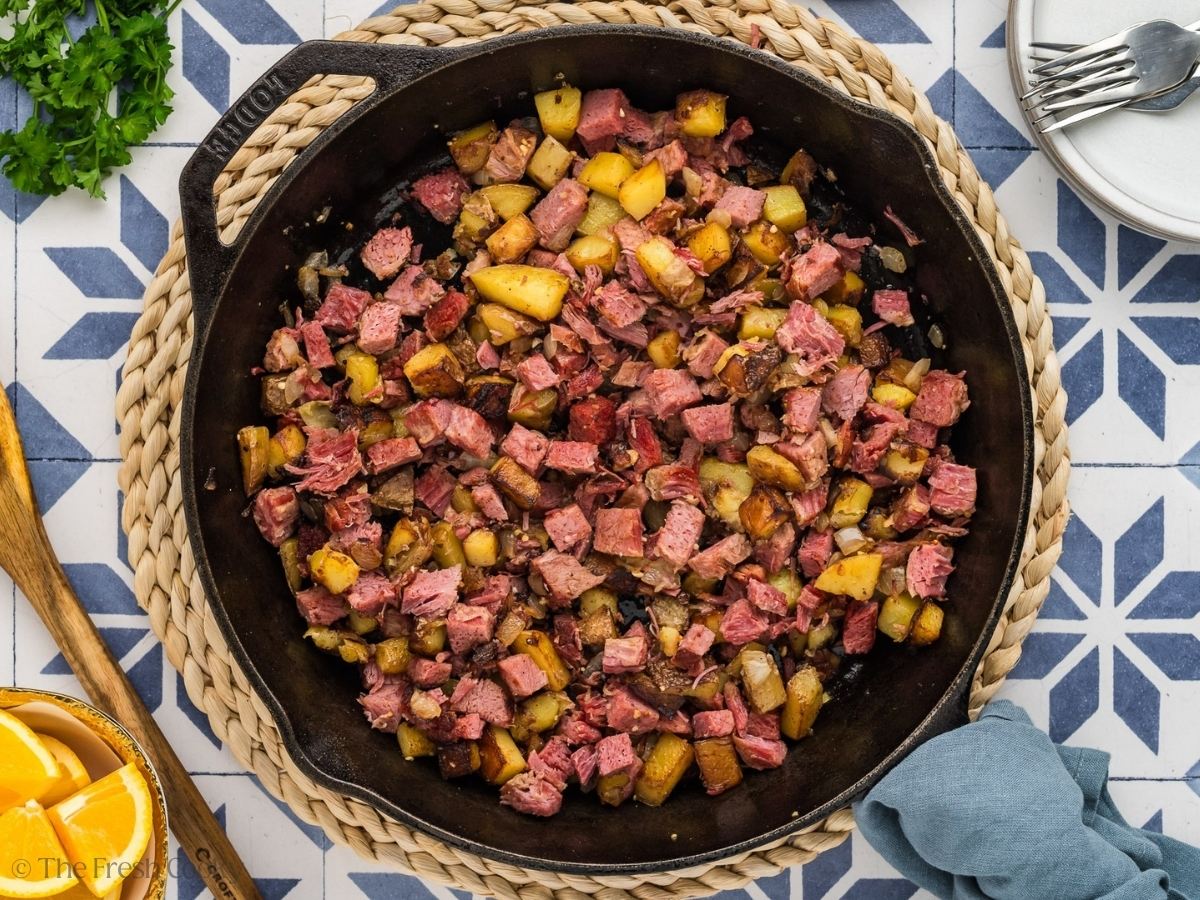 Adding corned beef to the hash.