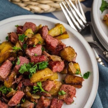 Corned beef hash on a plate with forks.