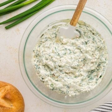 The mixed Knorr spinach dip in a glass bowl.