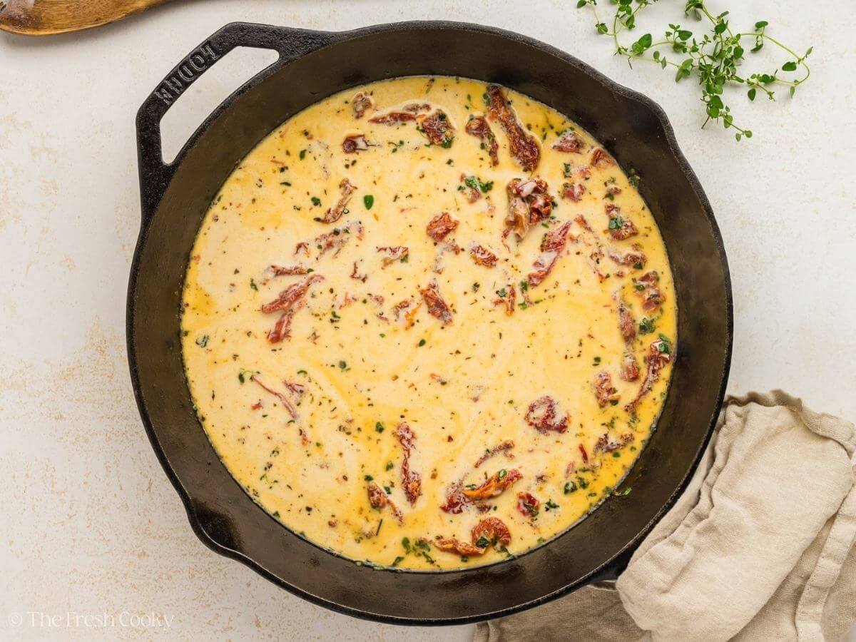 Marry me chicken sauce prepared in a cast iron skillet before adding the chicken back.