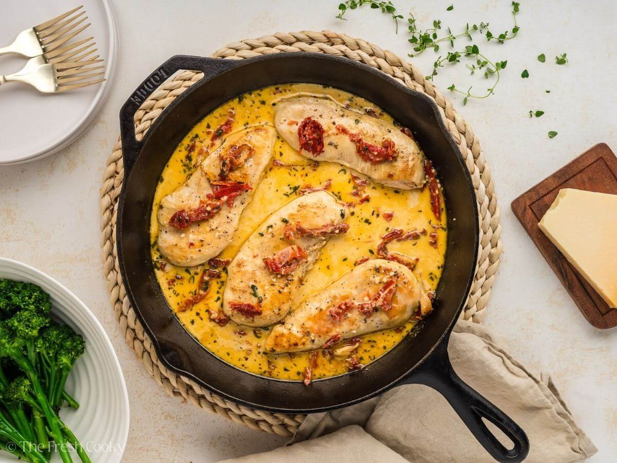 Chicken breast added back to the sauce to finish cooking in a cast iron skillet.