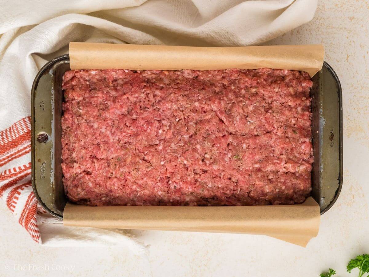 Meatloaf in the loaf pan before being baked.
